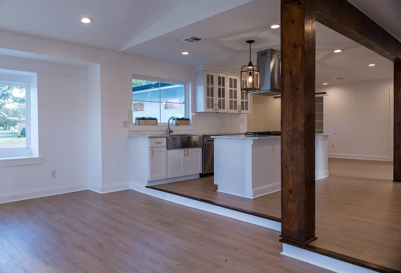 Open-concept kitchen and dining Open-concept kitchen and dining space after a wall removal, with a wood post and beam in Metairie, LA