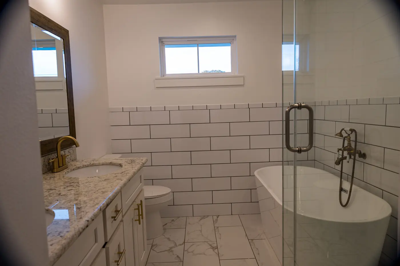 Primary bath with soaking tub Primary bath remodel with a freestanding tub, glass shower and subway tile walls in Metairie, LA